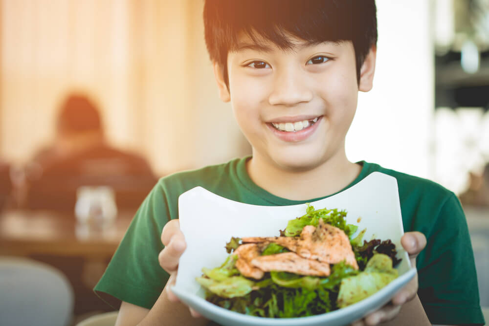 A teenager with food in his hands