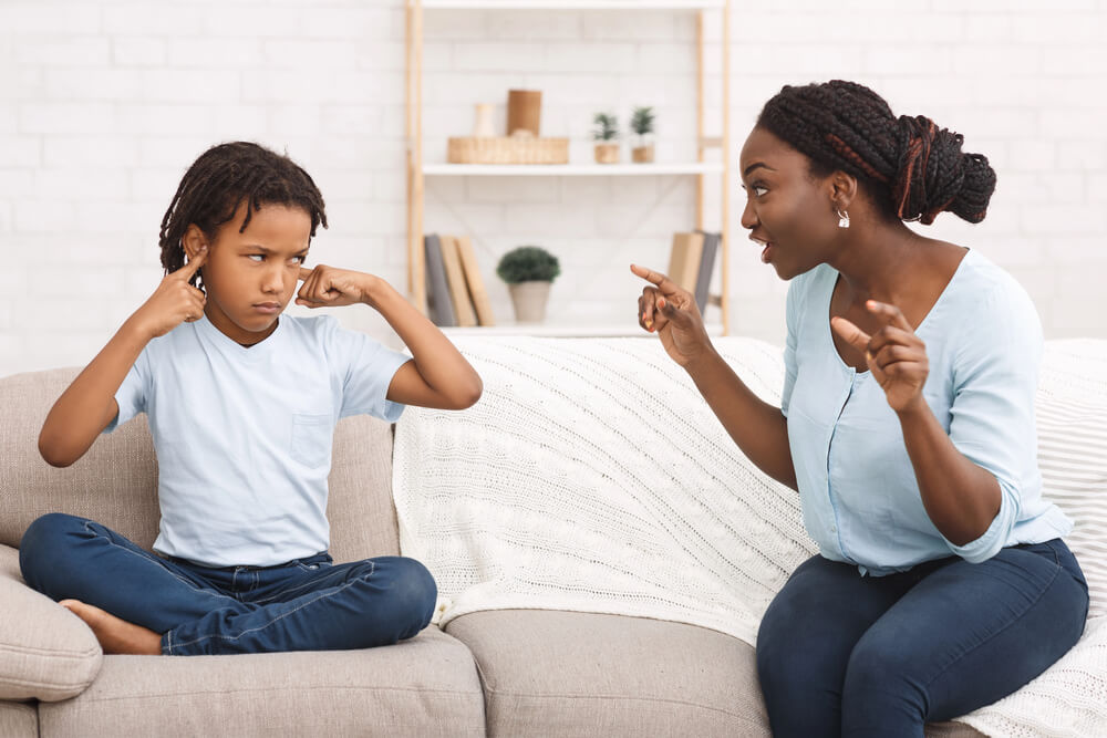 rebellious child covering his hears