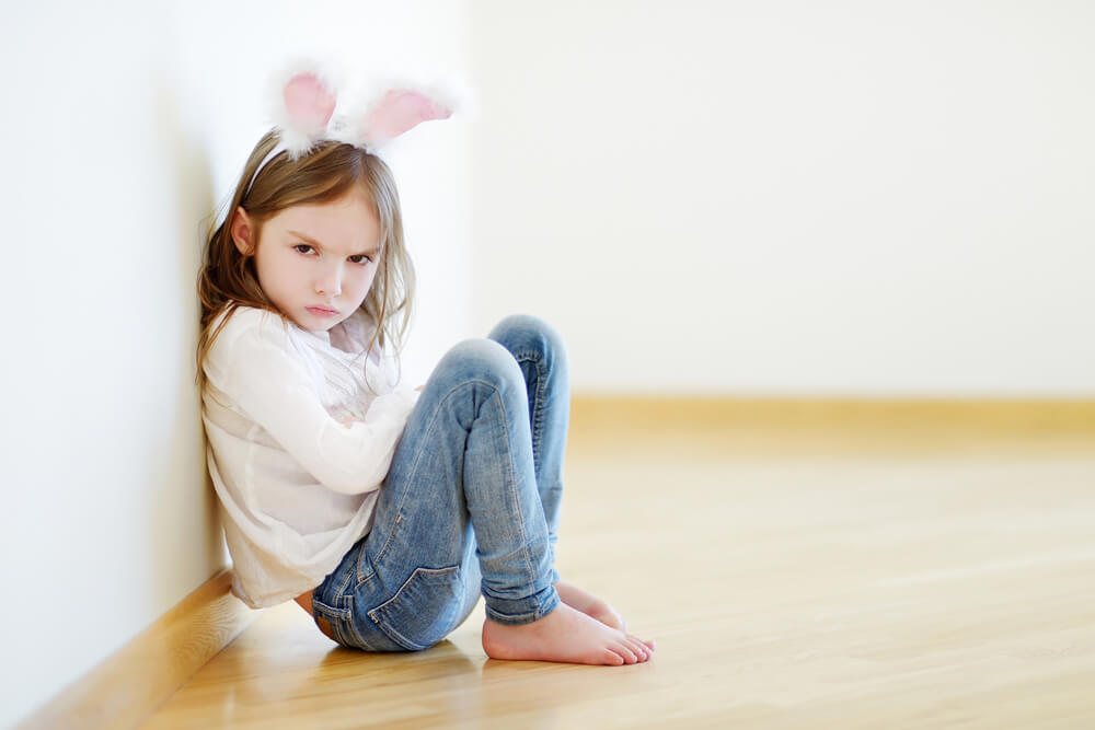 An angry child wearing little bunny