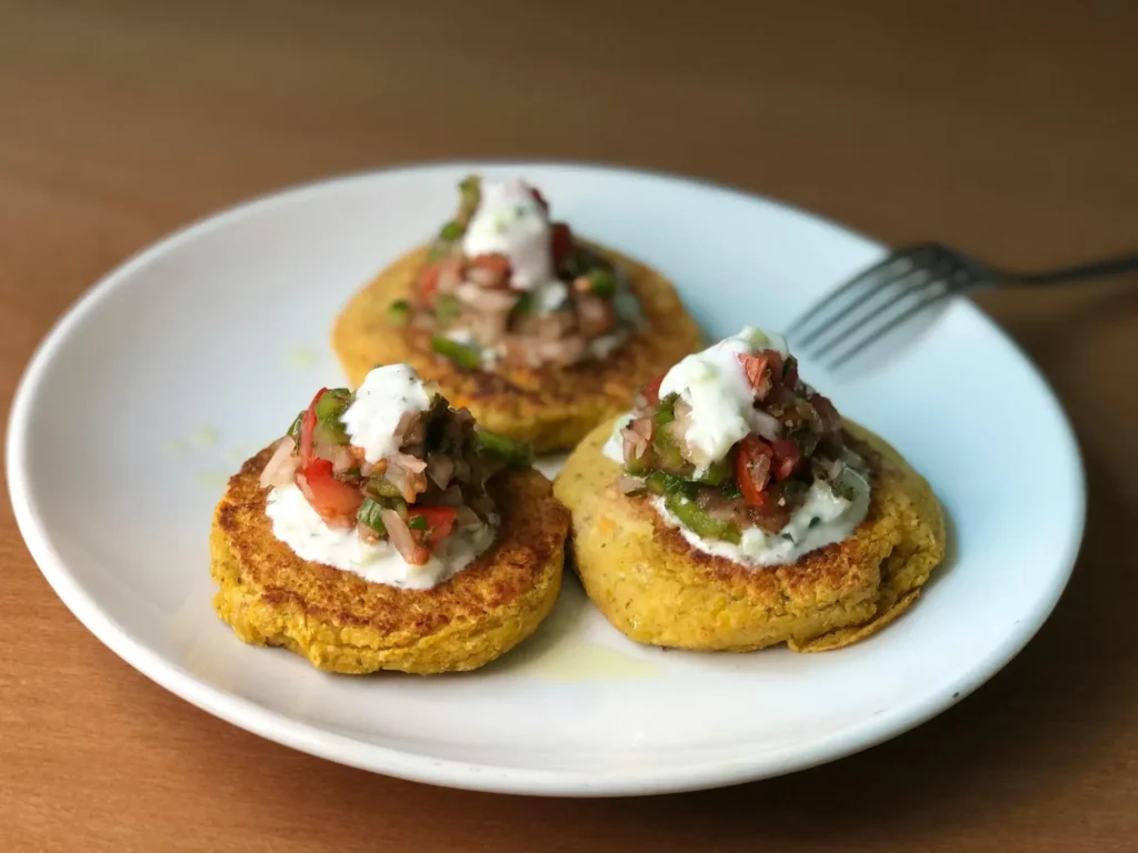 Tiny, soft vegetable fritters made from grated zucchini and sweet potato, perfect for a 10-month-old's self-feeding practice.