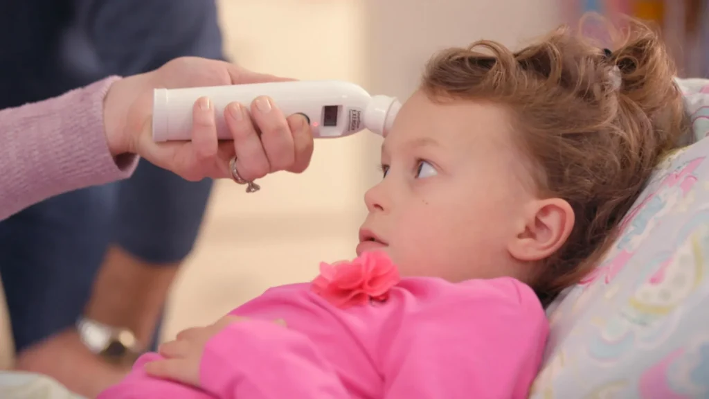 Child having their temperature taken