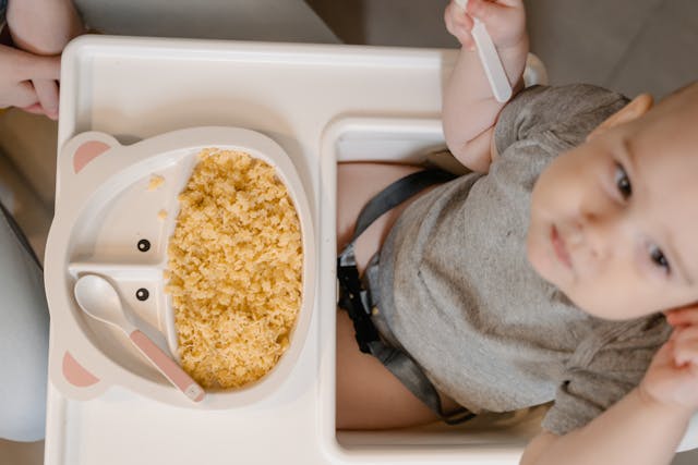 baby sitting on a high chair